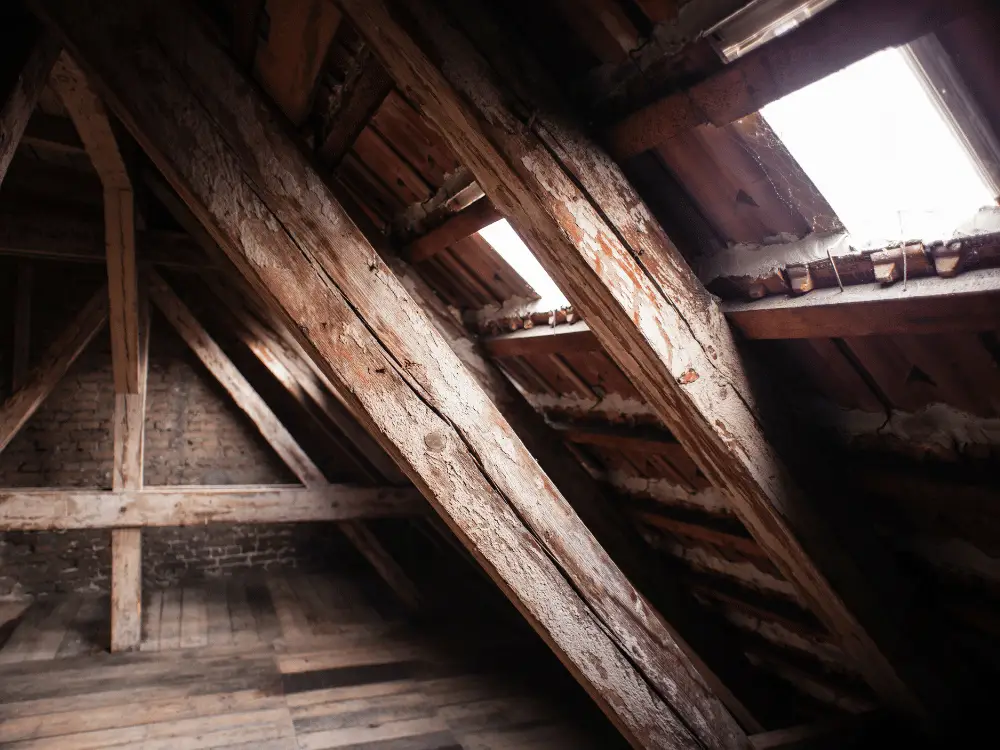 Old attic space interior with poor roof ventilation - Artisan Quality Roofing Old attic space interior with poor roof ventilation