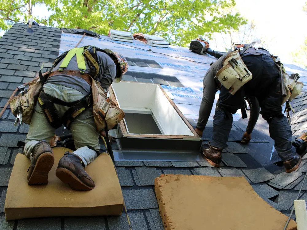 Crew replaces leaking skylight during roof replacement