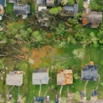 Aerial view neighborhood storm damage from hurricane weather - Artisan Quality Roofing Aerial view neighborhood storm damage from hurricane weather