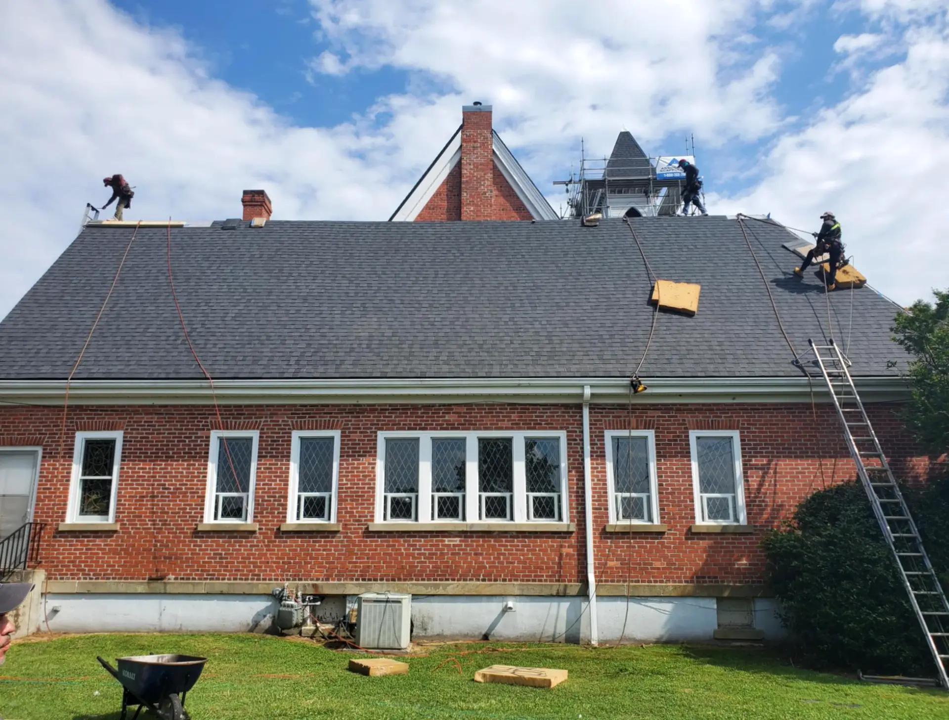 Crew-finishes-church-roof-slope - Artisan Quality Roofing Crew-finishes-church-roof-slope