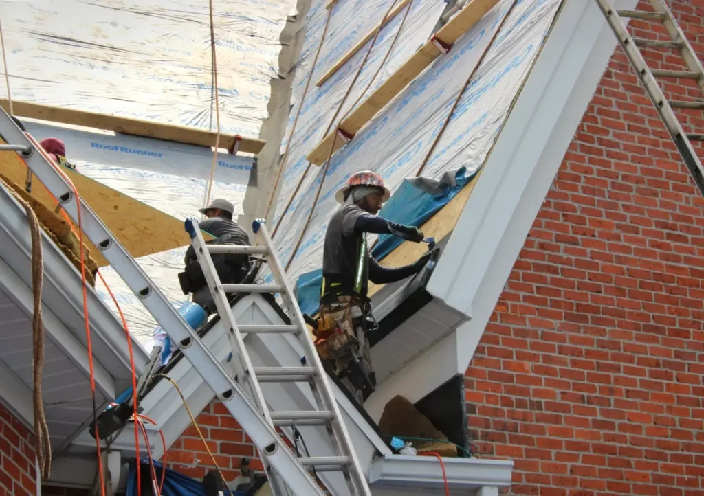 Roofing crew installs intake soffit vents1 - Artisan Quality Roofing Roofing crew installs intake soffit vents(1)