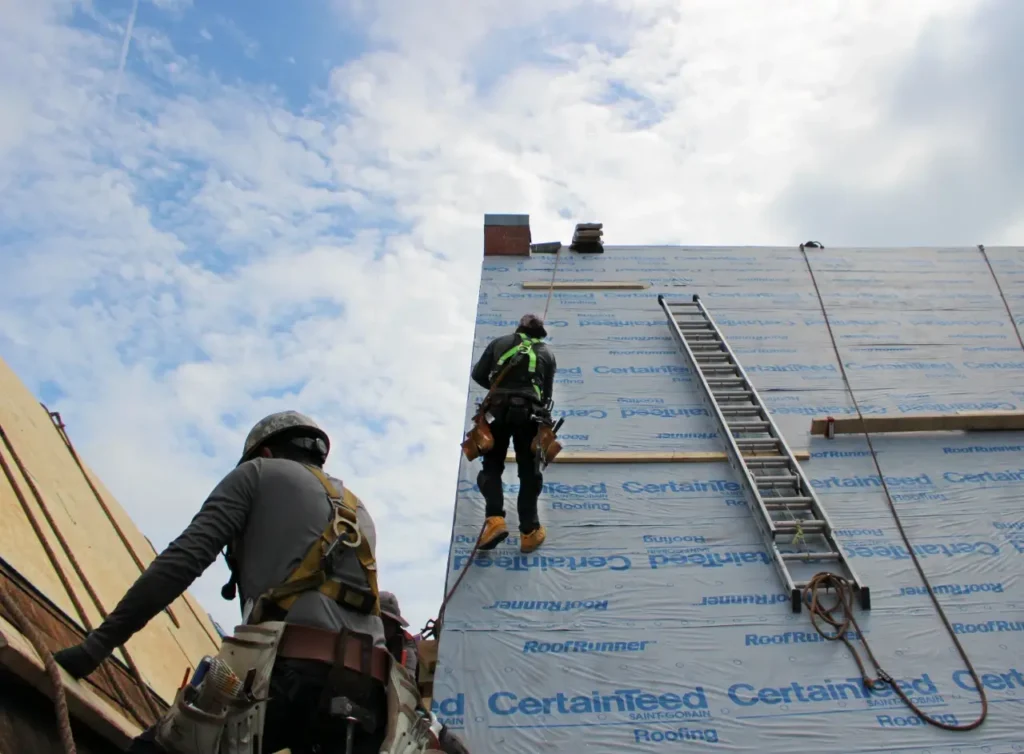Two roofers on steep roof slopes - church roof replacement - Artisan Quality Roofing Two roofers on steep roof slopes - church roof replacement