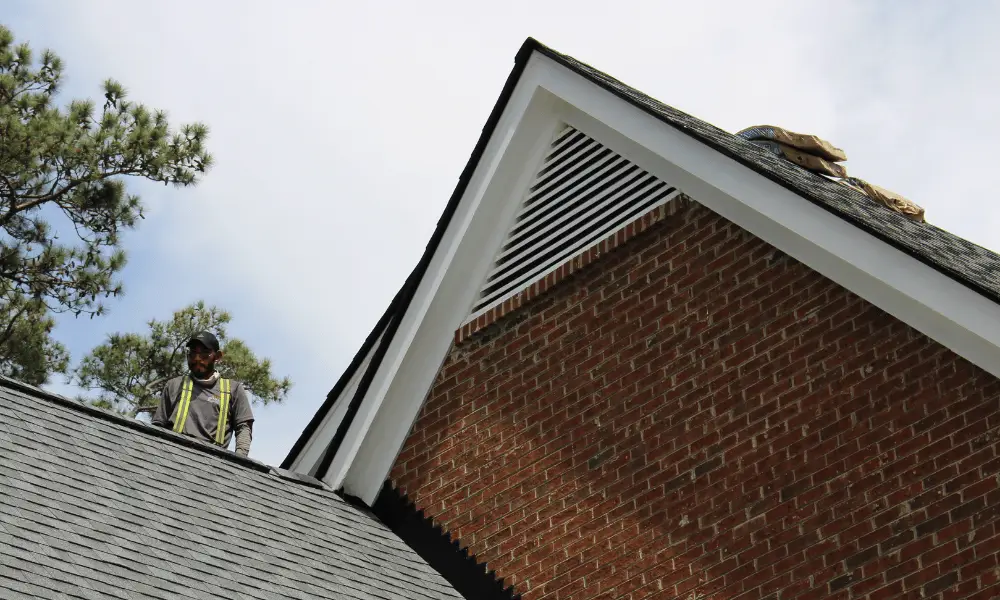 Technician installs ridge cap shingles